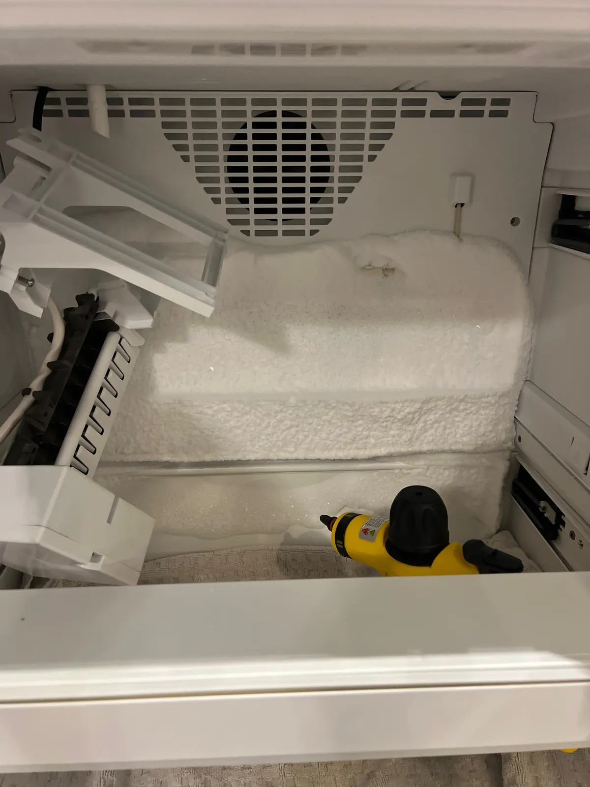 Steam defrosting a frozen freezer compartment