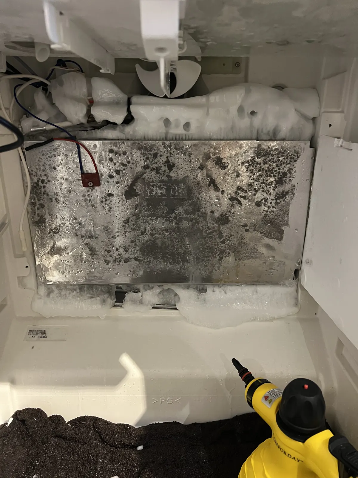 Frosted freezer evaporator cover before repair