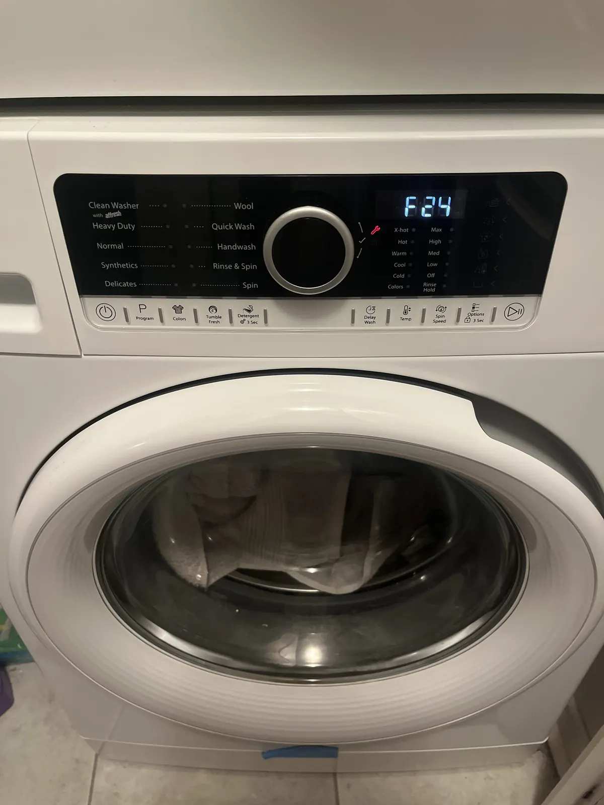Washing machine showing an F24 error code before repair