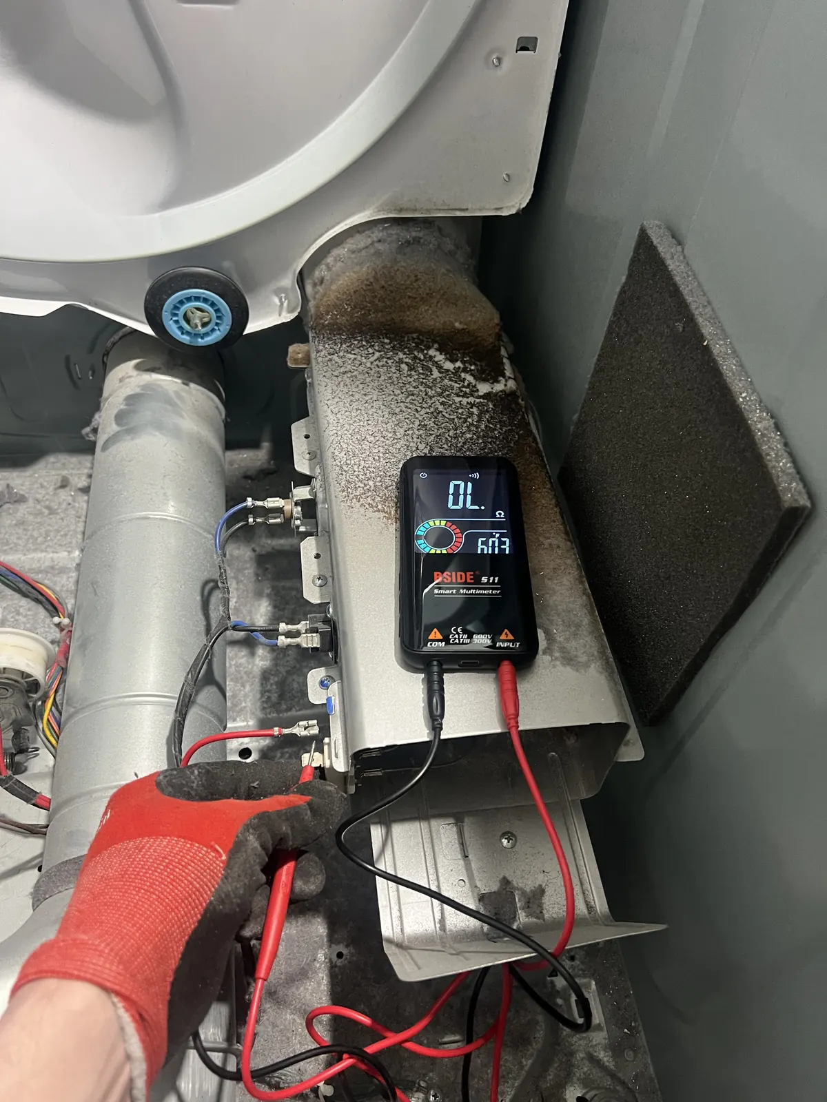 Swift Appliance Solution technician running multimeter diagnostics on an appliance