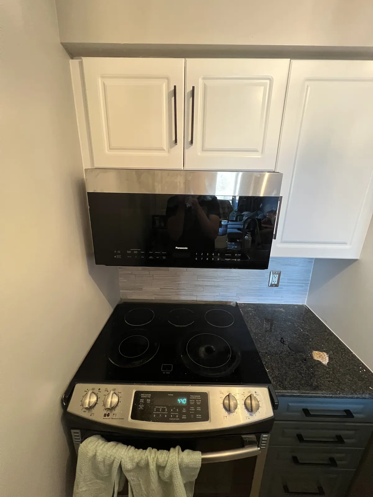 Installed Panasonic over-the-range microwave after repair